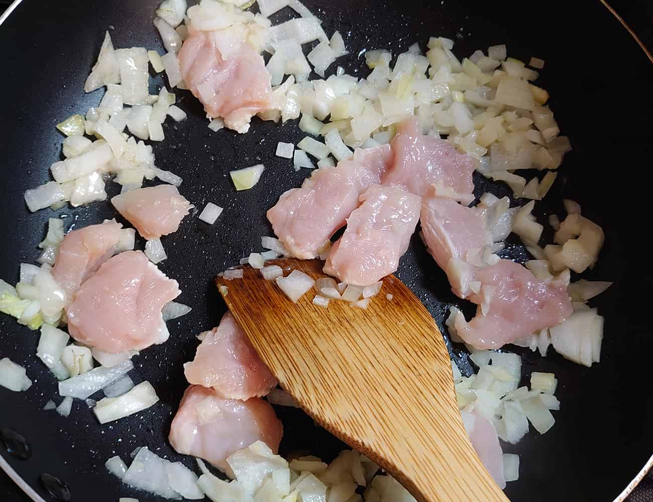 玉ねぎが透き通ってきたら、鶏胸肉を入れて炒める。